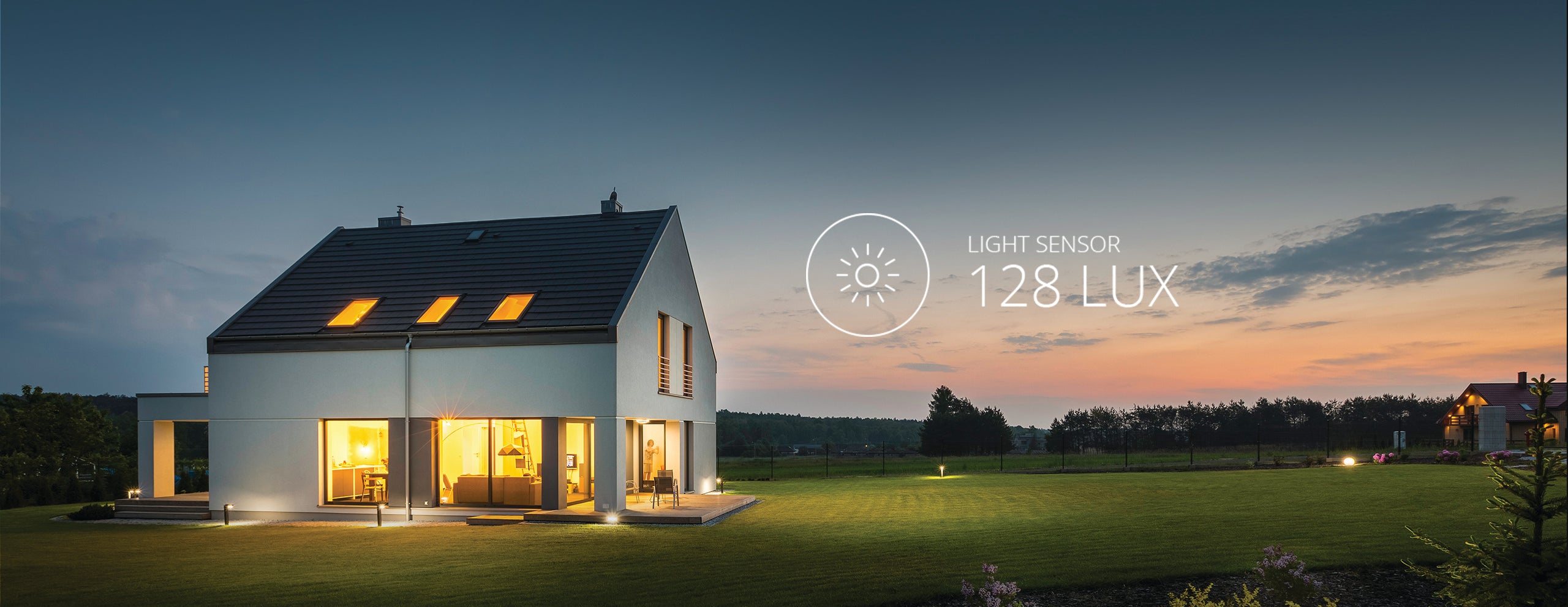 An internally lit house at sunset with a graphic depicting the LUX level. 